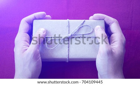 Man holding a gift. A man gives a gift.