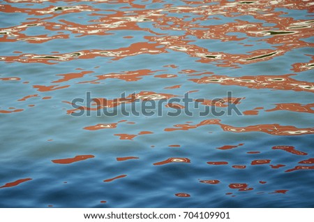 light panting on the rive surface,sea,ocean,blue,orange,sunshine