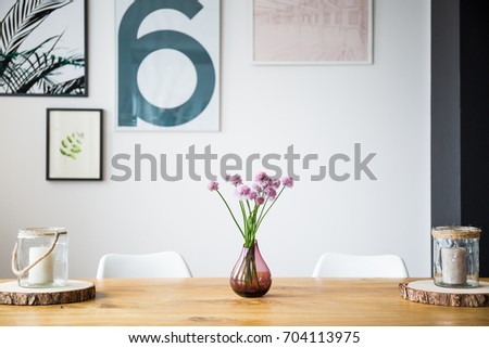 Wooden counter with vase with carnations in a modern flat