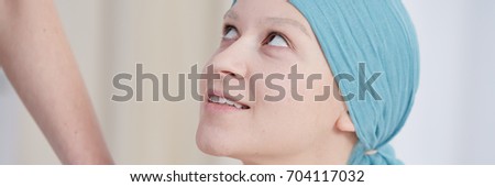 Young pretty woman with scarf after chemotherapy