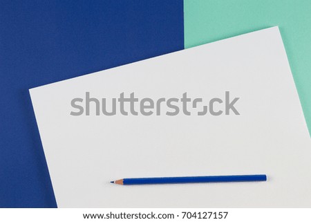 Blue colored pencils on blue color background.
