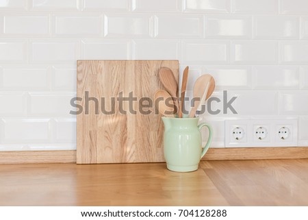 Kitchen utensils and dishware on wooden Countertop. Kitchen interior background