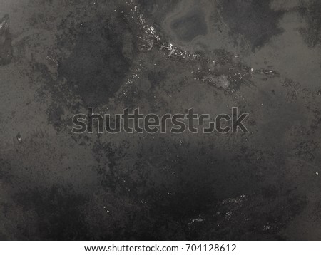 Bottle of blackened pans after long use. Stained iron background Royalty-Free Stock Photo #704128612