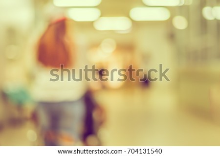 Abstract blur image of people in hospital walkway with bokeh for background usage. (vintage tone)