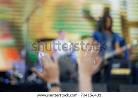 Abstraction of concert stage with blurry musicians during rock concert