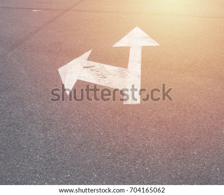 left and forward arrow on the streer with sunrise light