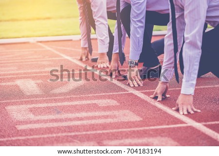 group of business people ready to start the race in track. business challenge concept. Royalty-Free Stock Photo #704183194