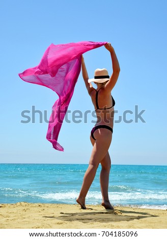 Beautiful caucasian girl with scarf on the Beach.Summer vacation by the sea.
