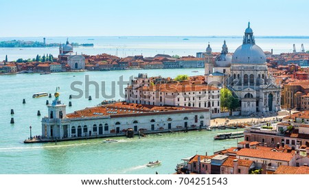Aerial view of Venice, Italy. Panorama of Dorsoduro in Venice from above. Landscape of Grand Canal, lagoon, sea and historical buildings of Venice. Beautiful skyline of Venice in summer. Travel theme Royalty-Free Stock Photo #704251543
