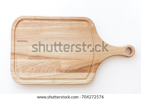 wooden cutting board on white background Royalty-Free Stock Photo #704272576