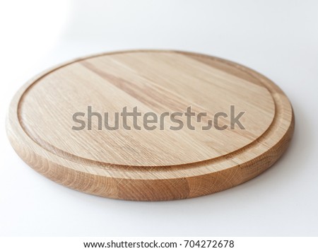 wooden cutting board on white background Royalty-Free Stock Photo #704272678