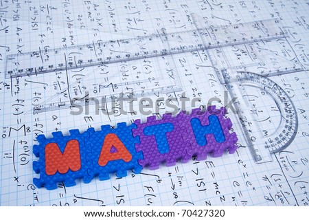 Math spelled out on calculus background with ruler and protractor