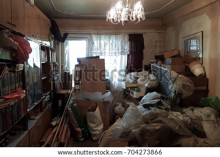 Apartment of a pensioner who suffers from compulsive hoarding, littered with trash and books Royalty-Free Stock Photo #704273866
