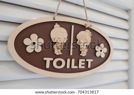 wooden toilet sign , Cute boy and girl  on White background .
