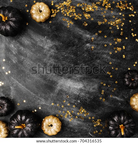 Halloween background with black and gold pumpkins. 