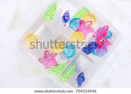 Acrylic shells in a box. Decoration for the aquarium. Decoration for a child's bathroom.