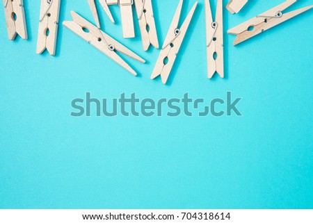 wooden clothes pins on pastel background