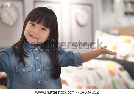 Asian children cute or kid girl wearing jeans and present or show my bedroom with modern clock on warm white because crazy or sales with space on soft focus and little noise at full picture size