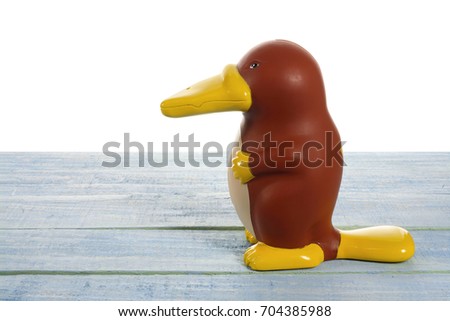 Platypus Figurine on Wooden Background