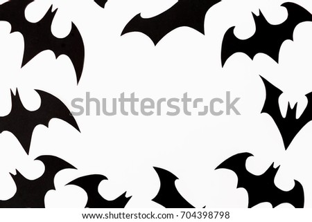 Halloween holiday frame concept. Handmade black paper bats on white background. Flat lay, top view.