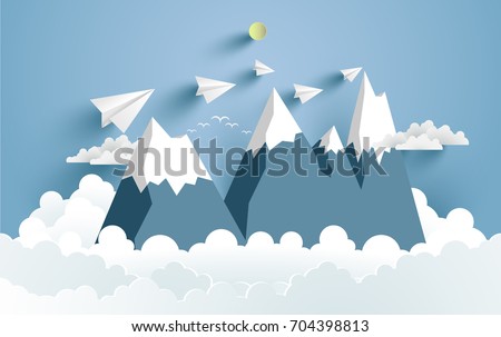 Mountains and clouds and there are paper planes on it with paper and craft art designs