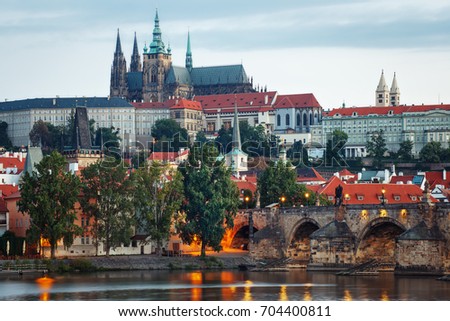 
It's evening in the city of Prague. View of the Prague Castle and the Charles Bridge. Czech Republic Royalty-Free Stock Photo #704400811