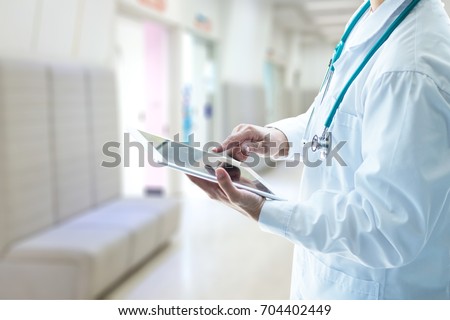 Professional medical physician doctor white uniform gown coat stethoscope hands holding digital patient chart information computer tablet in clinic hospital.Digital healthcare/ technology concept. Royalty-Free Stock Photo #704402449