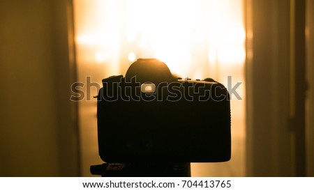 Silhouette of a camera on a tripod at Movie set in studio 