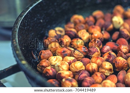 Hazelnut hazelnut fried in a frying pan / Roasted hazelnuts Royalty-Free Stock Photo #704419489