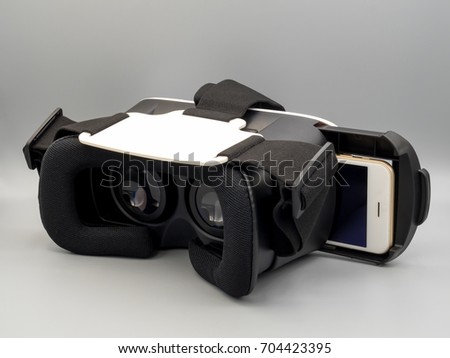 Packshot image of smartphone and virtual reality headset (VR Box) on gray background
