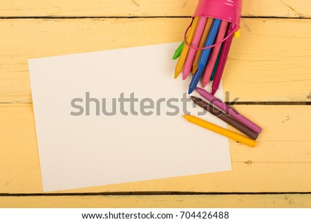 crayons and blank page on the desk