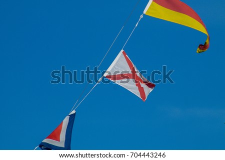 Navigational signal flags flying in the mast