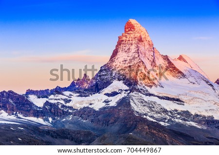 Zermatt, Switzerland. East and north faces of the Matterhorn at sunrise. Royalty-Free Stock Photo #704449867