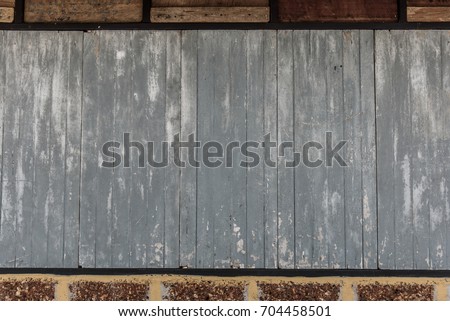 Old wooden plank and brick wall pattern. Antique rough and rustic wall of rural house.