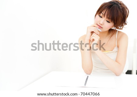 beautiful asian woman thinking on the table