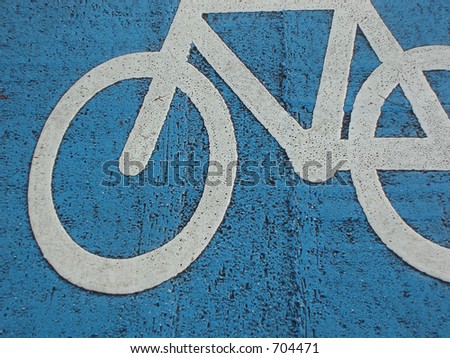 Painted sign of bicycle painted on the road â€“ blue background