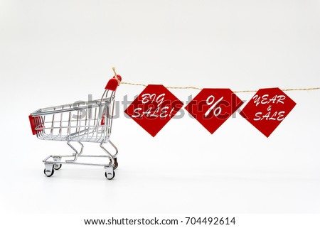 concept of shopping, trolley and there is a rope hanging paper with the words "BIG SALE, % AND YEAR & SALE".