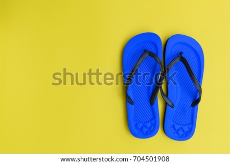 Flat lay,blue beach flip flops shoe on yellow background,top view