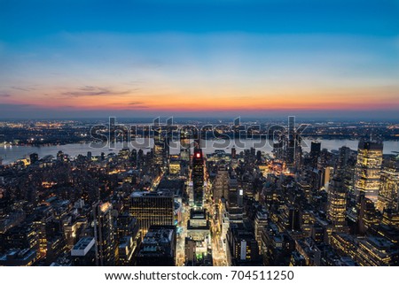 New York City skyline aerial view with urban skyscrapers and Hudson river at sunset during summer. Viewing from the Empire State Building.