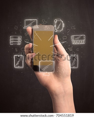 Caucasian hand in business suit holding a smartphone with hand-drawn icons