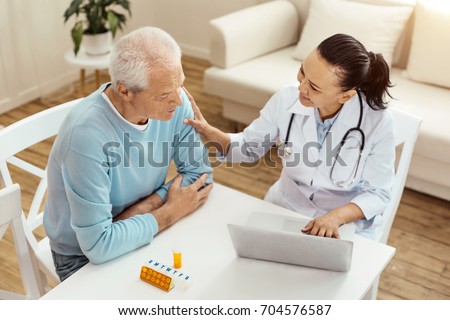 Cheerful friendly doctor comforting her patient