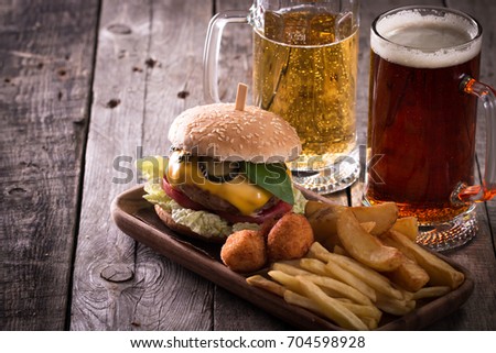 fast food menu with hamburger, , french fries and beer on wooden background