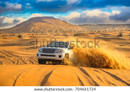 Offroad desert safari in Dubai. (dune bashing). Royalty-Free Stock Photo #704661724
