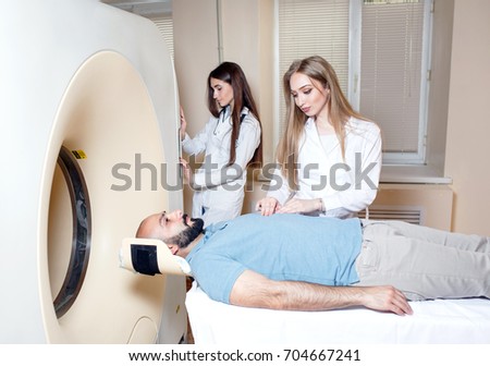 Happy patient undergoing mri scan at hospital.