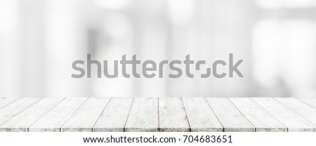 Wood table top and blurred abstract background from interior building banner background - can used for display or montage your products.
