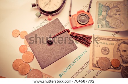 Graduation cap on book, Business News, Concept of graduate education in university, requires a lot foreign currency Dollars bring success in study famous institution, Concept of abroad international