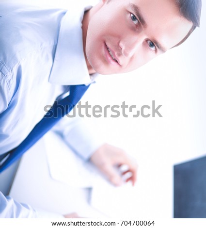 Businessman sitting at table in office lobby,using laptop computer