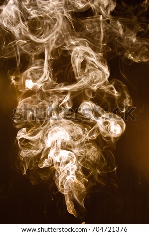 Brown smoke abstract on black background.