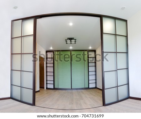 Wide angle photo of the repair of interior of new living room with sliding doors coupe in Japanese style Shoji with a wardrobe. Modern Asian design in apartment Studio.