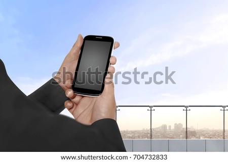 Hand holding cellphone with empty blank screen for copyspace